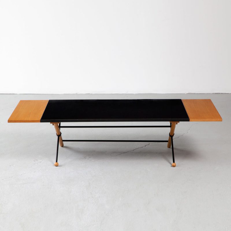 Coffee table in walnut, steel, and plastic laminate with folding leaves