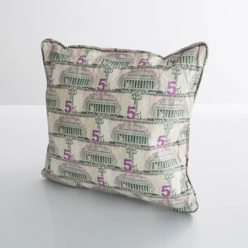 Pillow in cut, pieced, and stitched five-dollar bills.